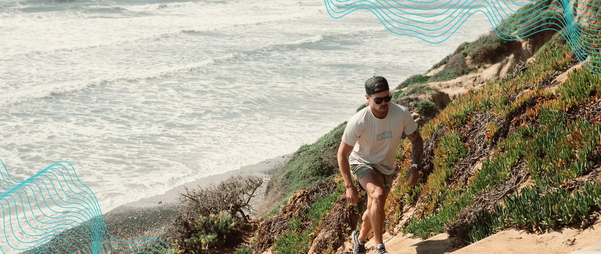 A man running up a coastal trail above the sea
